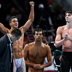 Paolo Conte Bonin, Thomas Ceccon and Alessandro Miressi of Italy celebrate after winning the bronze medal in the swimming 4x100m Freestyle Relay Men Final during the Paris 2024 Olympic Games at La Defense Arena in Paris (France), July 27, 2024.